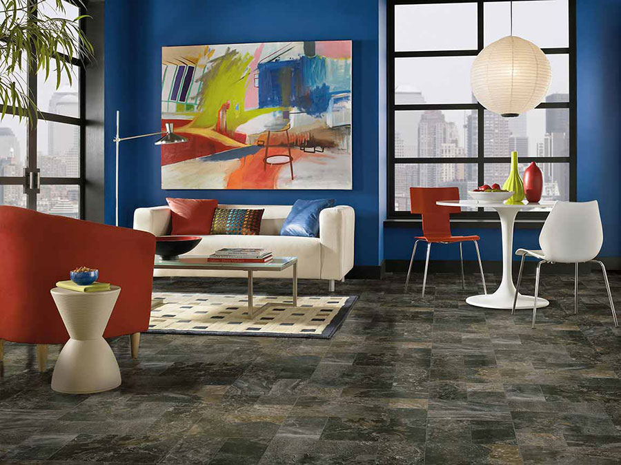 Open living room design with glossy blue painted wall decorated with red and white art deco furniture.